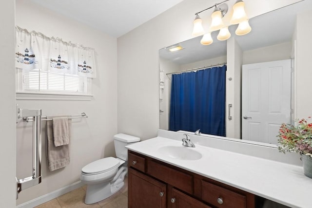 bathroom with tile patterned floors, vanity, and toilet