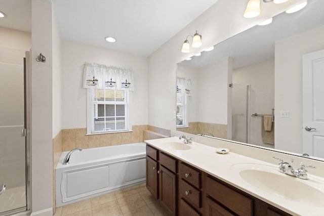 bathroom with tile patterned flooring, vanity, and independent shower and bath