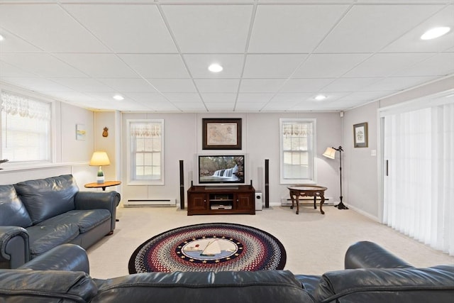 living room with a paneled ceiling, light colored carpet, and a baseboard radiator