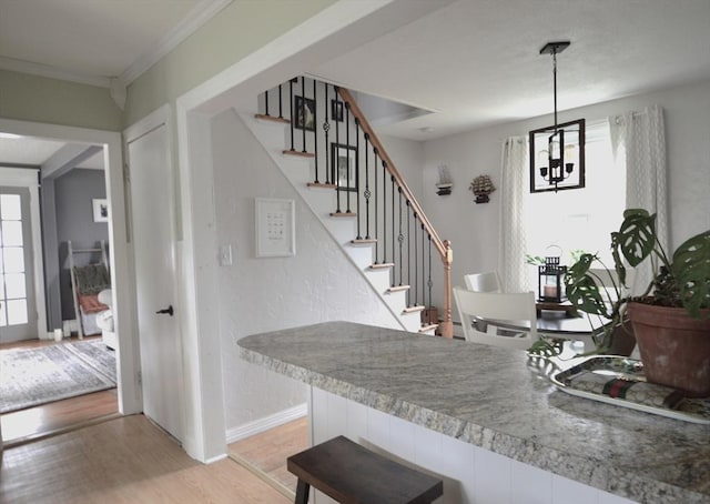 11 Dallas St, Worcester, MA 01604 - stairway with wood finished floors, a chandelier, baseboards, and ornamental molding