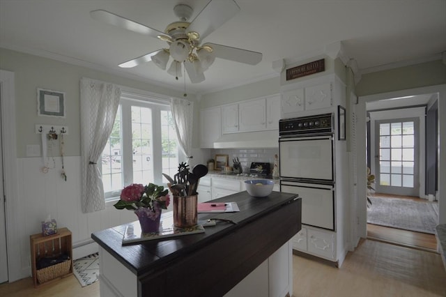 11 Dallas St, Worcester, MA 01604 - kitchen featuring white double oven, crown molding, ceiling fan, white cabinetry, and light wood-type flooring