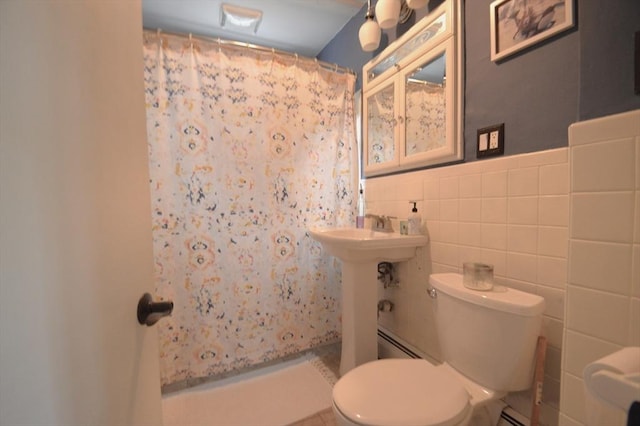 11 Dallas St, Worcester, MA 01604 - bathroom with toilet, a shower with shower curtain, a baseboard heating unit, tile walls, and a wainscoted wall