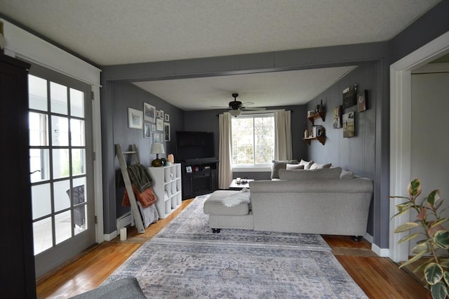 11 Dallas St, Worcester, MA 01604 - living area featuring wood finished floors, ceiling fan, baseboards, and a baseboard heating unit