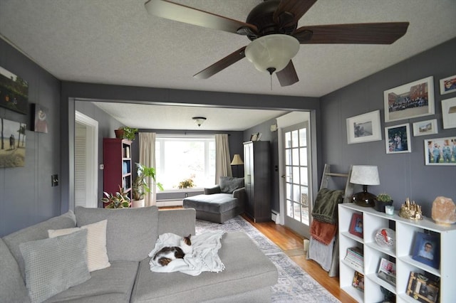11 Dallas St, Worcester, MA 01604 - living area with wood finished floors, ceiling fan, and a textured ceiling