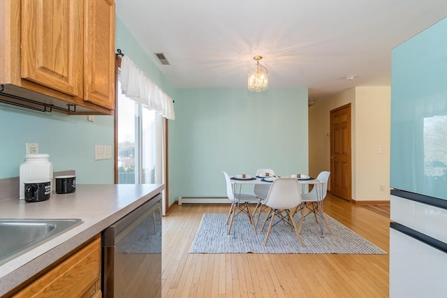 kitchen with a baseboard heating unit, hanging light fixtures, a notable chandelier, stainless steel dishwasher, and light wood-type flooring