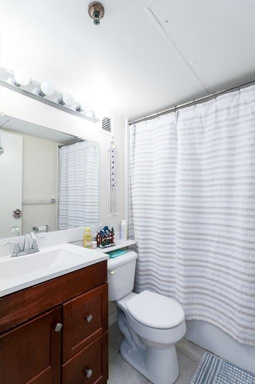 bathroom featuring tile patterned flooring, vanity, and toilet