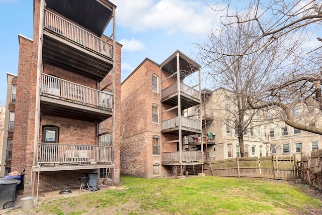 view of apartment building / complex featuring fence