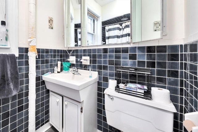 bathroom with tile walls and vanity