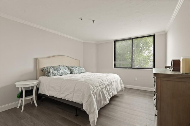 bedroom with wood-type flooring and ornamental molding