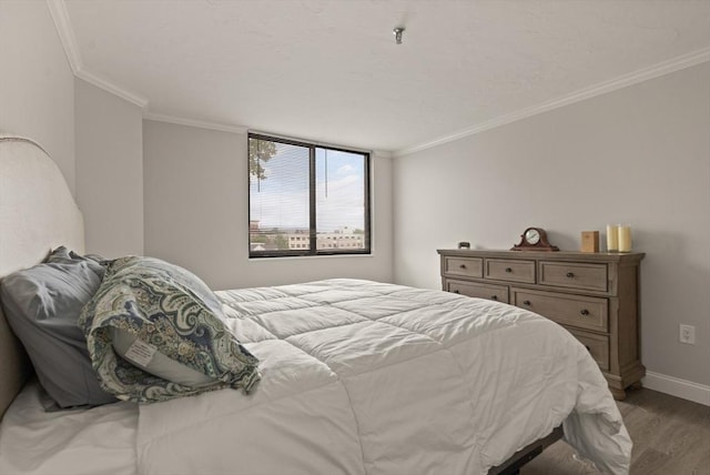 bedroom featuring hardwood / wood-style flooring and crown molding