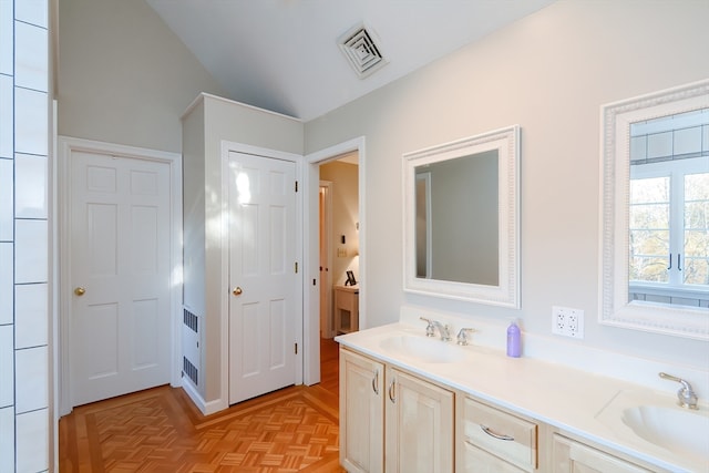 bathroom featuring vanity, parquet floors, and lofted ceiling