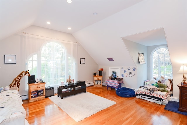 interior space featuring lofted ceiling, wood-type flooring, and baseboard heating