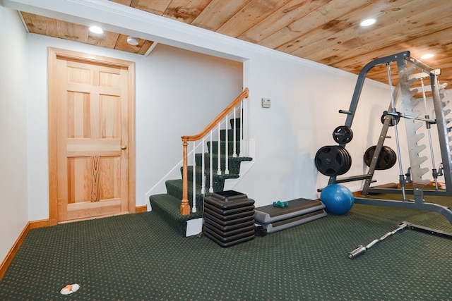 exercise area with wood ceiling, crown molding, and carpet floors