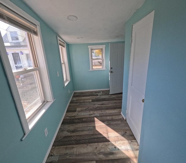 hallway with dark hardwood / wood-style flooring