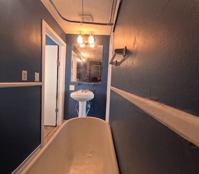 bathroom featuring a tub to relax in and sink