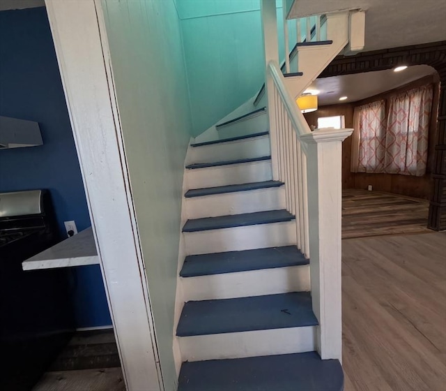 staircase with hardwood / wood-style flooring