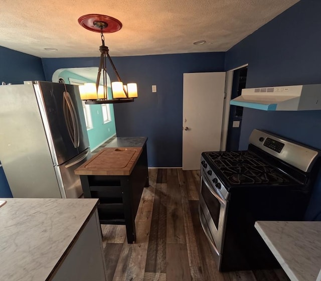 kitchen featuring decorative light fixtures, stainless steel appliances, dark hardwood / wood-style floors, and exhaust hood