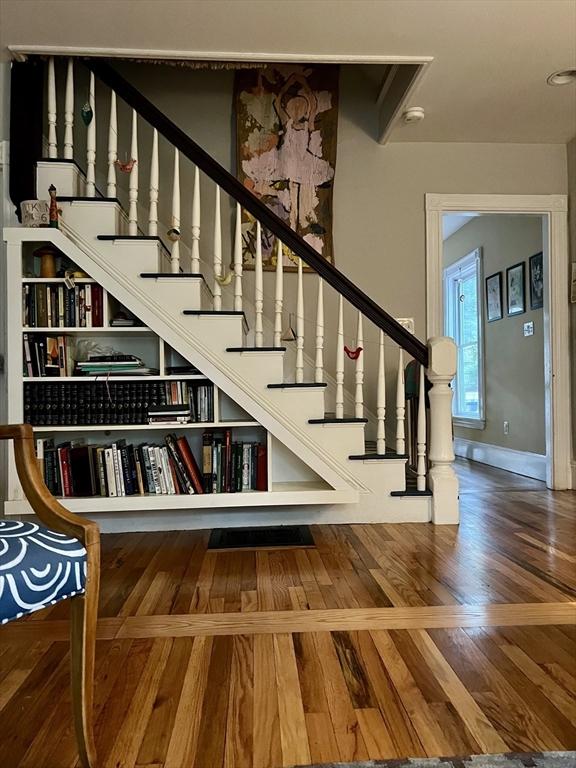 18 Rushmore St, Boston, MA 02135 - staircase featuring wood finished floors and baseboards