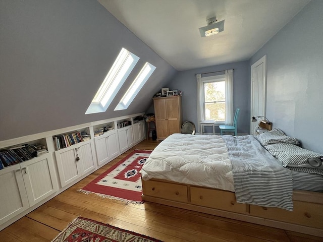 18 Rushmore St, Boston, MA 02135 - bedroom featuring a skylight, light wood-style floors, and vaulted ceiling