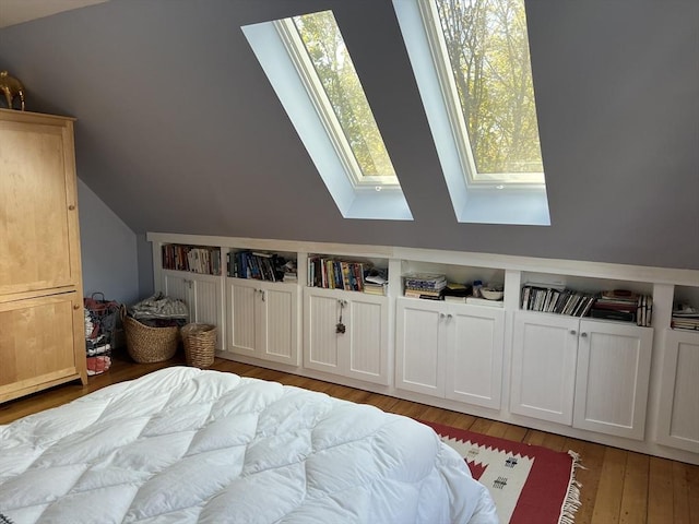 18 Rushmore St, Boston, MA 02135 - bedroom with a skylight, lofted ceiling, and light wood-style floors