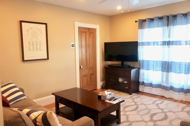 18 Rushmore St, Boston, MA 02135 - living area with light wood finished floors, a ceiling fan, and baseboards