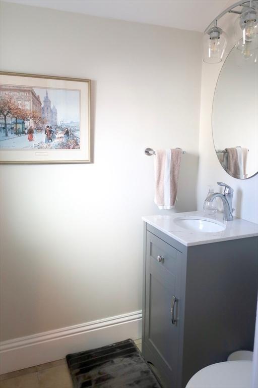 18 Rushmore St, Boston, MA 02135 - bathroom with vanity, toilet, and tile patterned flooring