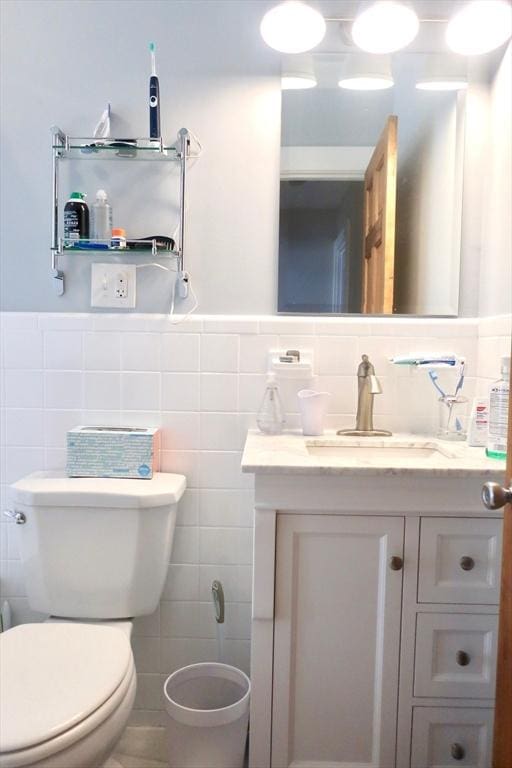 18 Rushmore St, Boston, MA 02135 - half bathroom with tile walls, vanity, toilet, and wainscoting