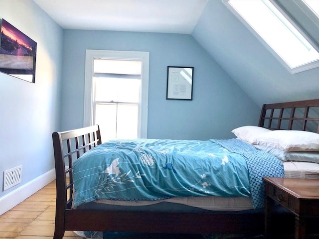 18 Rushmore St, Boston, MA 02135 - bedroom with a skylight, wood finished floors, and lofted ceiling
