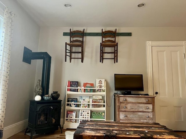 18 Rushmore St, Boston, MA 02135 - bedroom with a wood stove, wood finished floors, recessed lighting, and baseboards