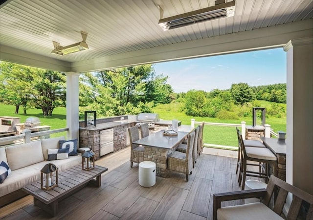 view of patio featuring exterior kitchen, a grill, and an outdoor hangout area