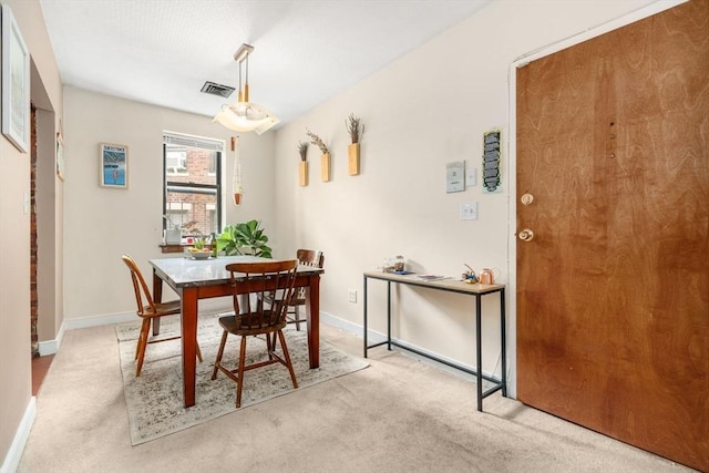 dining room featuring carpet and baseboards