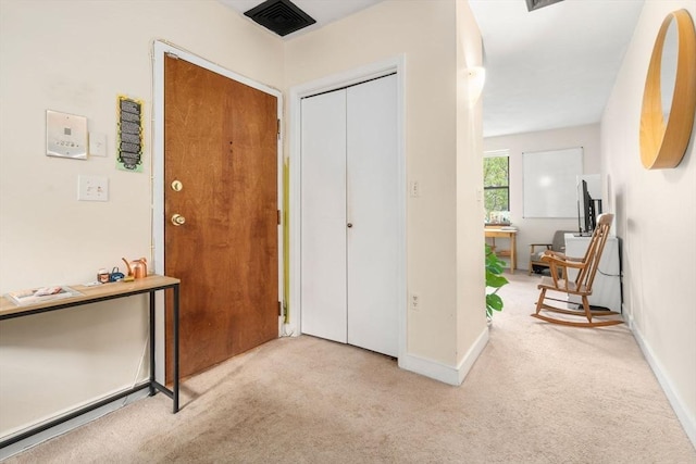 entrance foyer featuring carpet flooring and baseboards