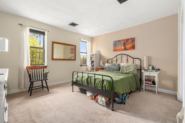 bedroom with multiple windows, carpet, and baseboards