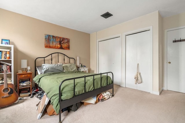 carpeted bedroom with two closets