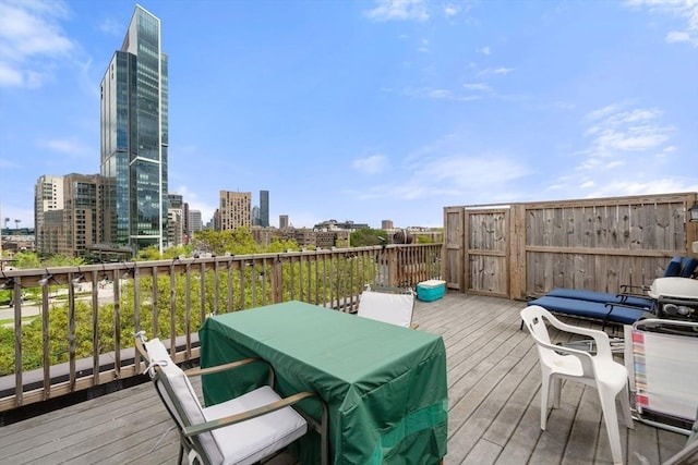 wooden deck featuring a view of city and outdoor dining area