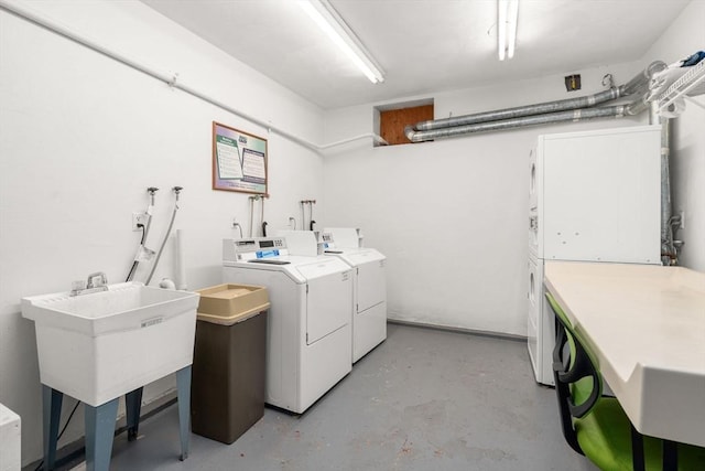 community laundry featuring washing machine and dryer