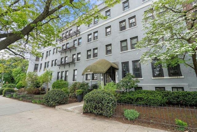 view of apartment building / complex featuring fence
