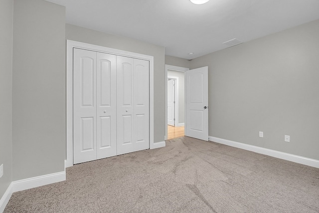 unfurnished bedroom with carpet flooring and a closet