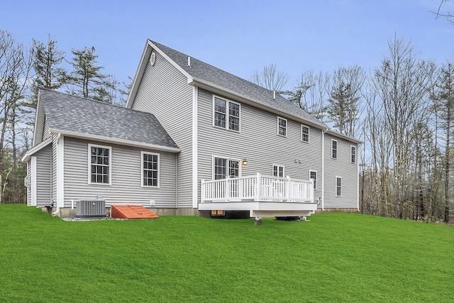 back of house with central AC, a yard, and a deck