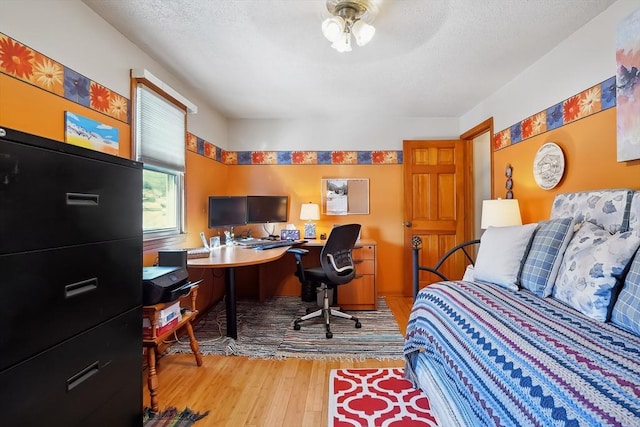 241 Broadway Rd Unit 56, Dracut, MA 01826 - bedroom with wood finished floors, a desk, and a textured ceiling