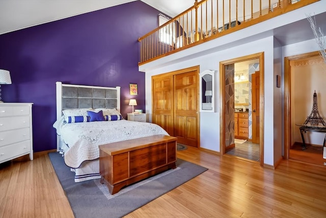 241 Broadway Rd Unit 56, Dracut, MA 01826 - bedroom featuring a high ceiling, wood finished floors, baseboards, and connected bathroom