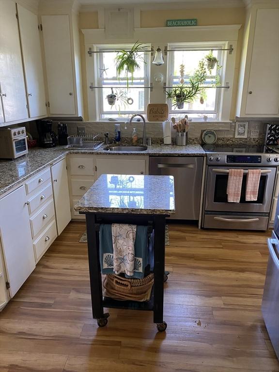 452 W Clinton St, New Bedford, MA 02740 - kitchen featuring stainless steel appliances, a sink, and white cabinetry