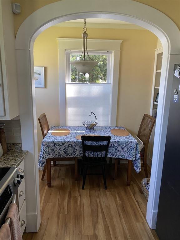 452 W Clinton St, New Bedford, MA 02740 - dining space with arched walkways and light wood finished floors
