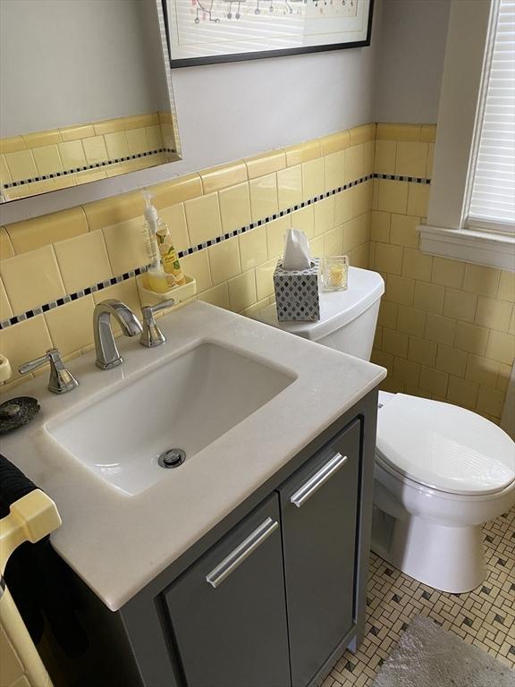 452 W Clinton St, New Bedford, MA 02740 - half bath with tile walls, toilet, vanity, and wainscoting