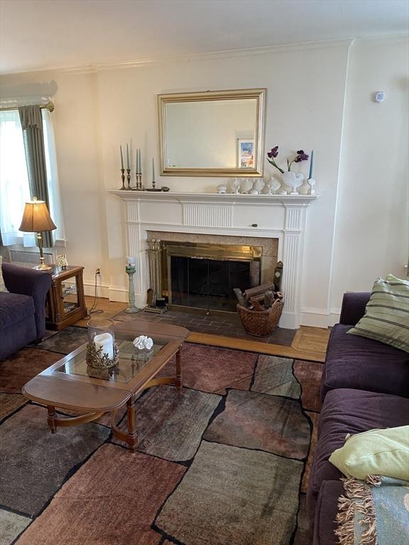 452 W Clinton St, New Bedford, MA 02740 - living room with a fireplace with flush hearth, crown molding, and baseboards