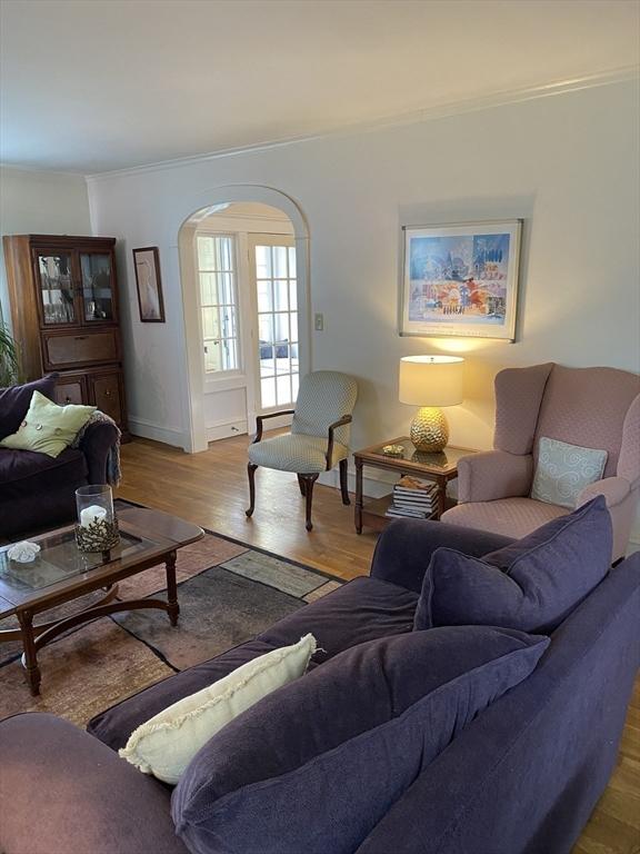 452 W Clinton St, New Bedford, MA 02740 - living room featuring ornamental molding, wood finished floors, baseboards, and arched walkways