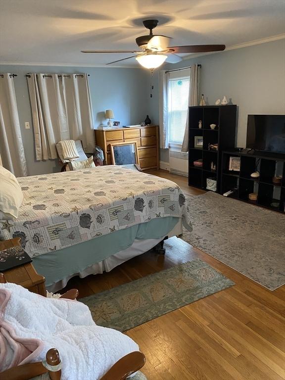 452 W Clinton St, New Bedford, MA 02740 - bedroom featuring wood finished floors, crown molding, and a ceiling fan