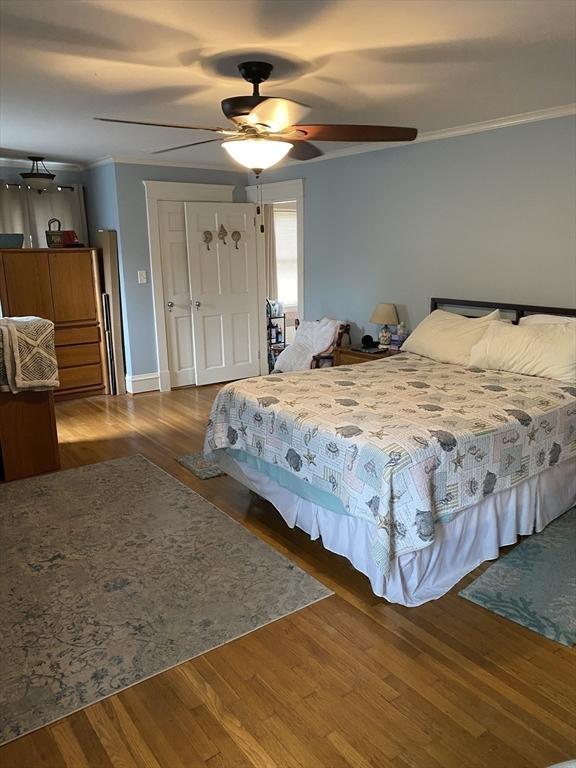 452 W Clinton St, New Bedford, MA 02740 - bedroom with wood finished floors, ceiling fan, a closet, and crown molding