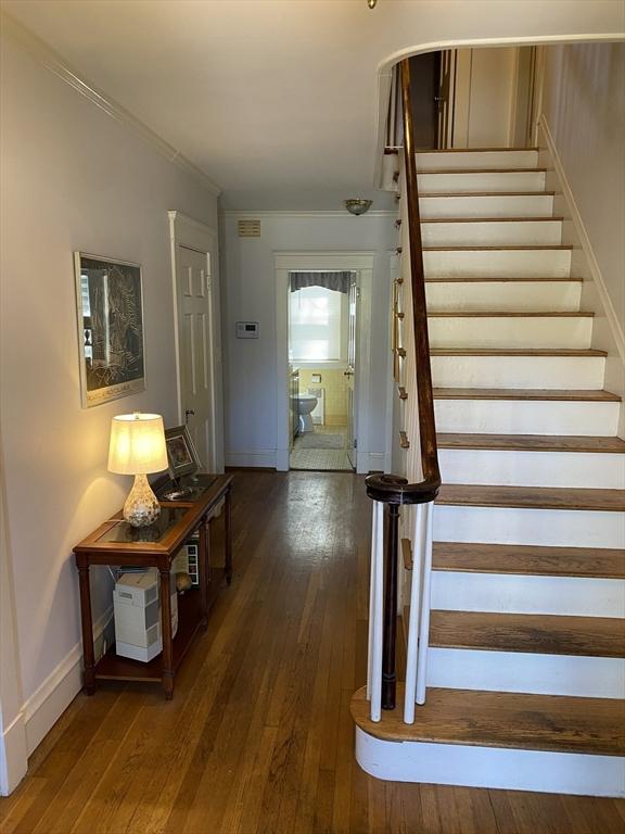 452 W Clinton St, New Bedford, MA 02740 - staircase featuring wood-type flooring, baseboards, and ornamental molding