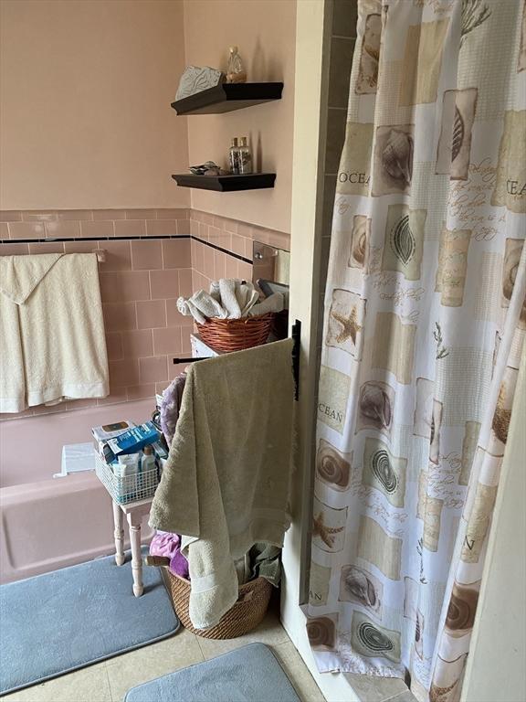 452 W Clinton St, New Bedford, MA 02740 - bathroom featuring tile patterned flooring, a shower with curtain, and tile walls